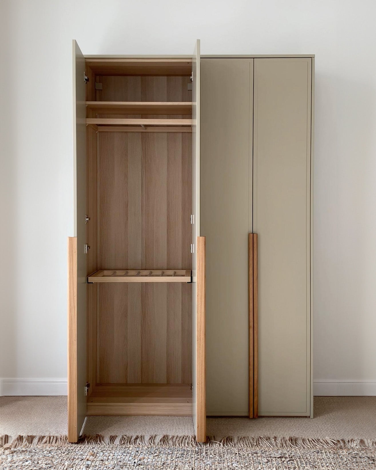 A.S.Helsingö Lalax wardrobe in ash green colour with open doors and Ikea pax frame inside